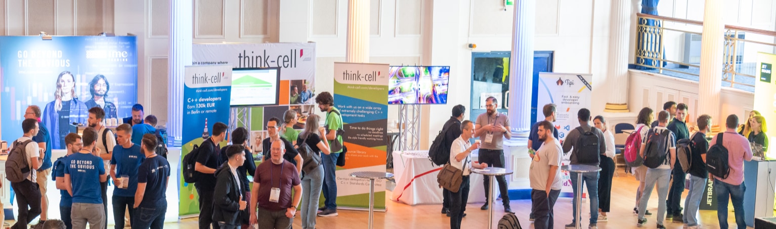 C++ on Sea 2023 attendees chatting in the exhibition area